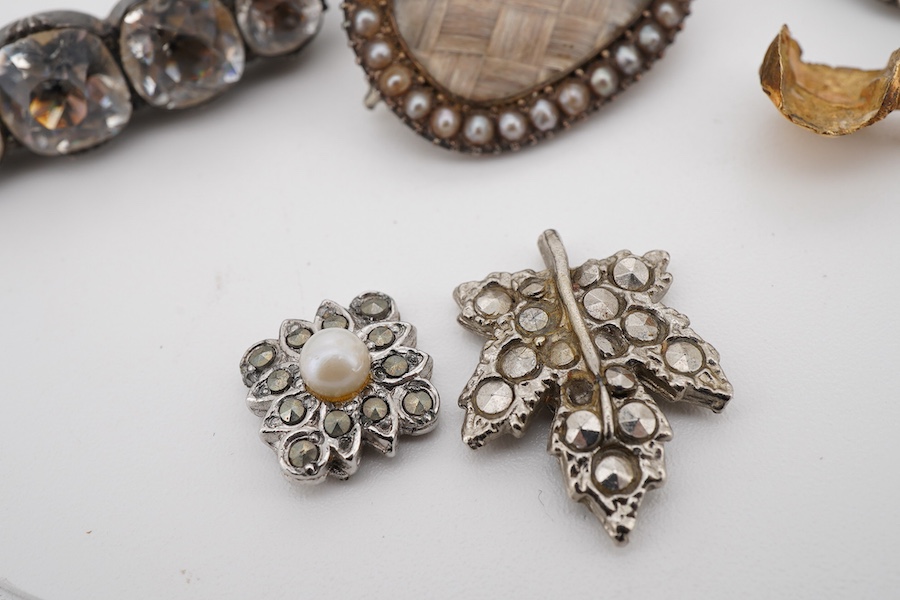 Assorted jewellery including a 19th century mourning brooch with plaited hair and split pearl set border, 22mm, a yellow metal mounted tooth, three marcasite set items and a paste set brooch.